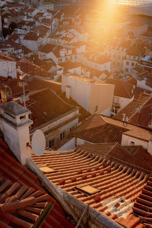 the sun shines on the rooftops of residential houses