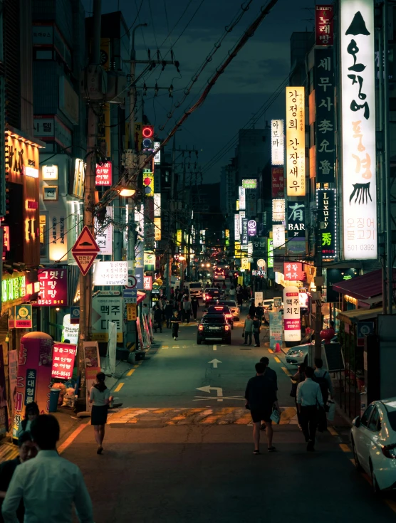 a night time po of a street with lots of signs