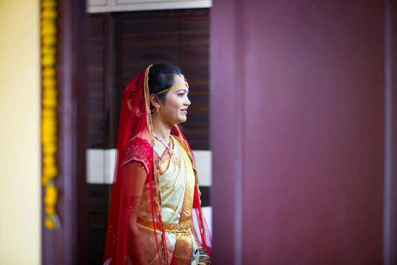 a woman in a red and yellow wedding outfit