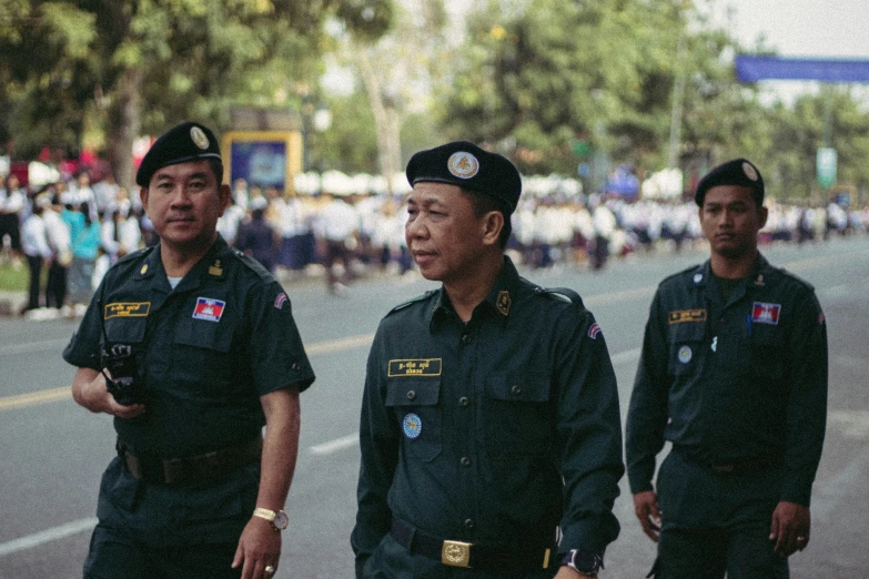 three asian men in uniform are standing beside each other