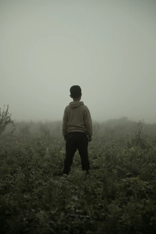 a man standing on top of a lush green field