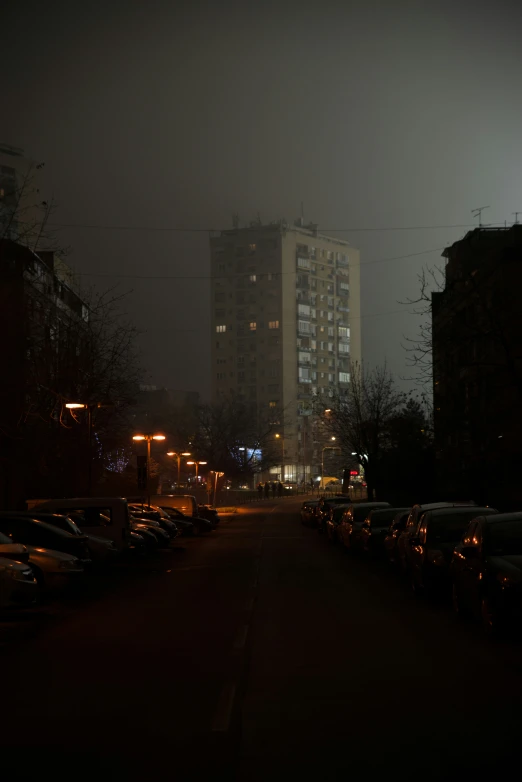 a city at night lit by street lights and tall buildings