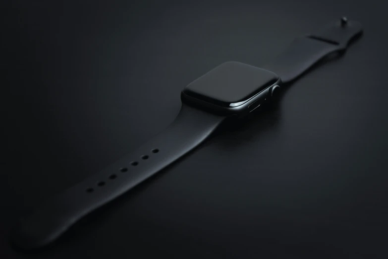 a black apple watch strap that has an apple logo on the back of it