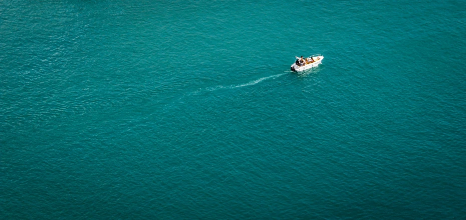 a small boat sailing across a large body of water