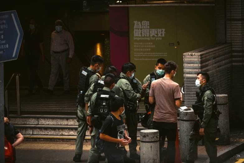 a group of people in military green gear talking