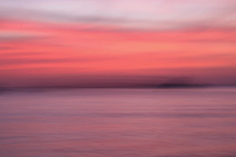 a pink and blue sky with white clouds