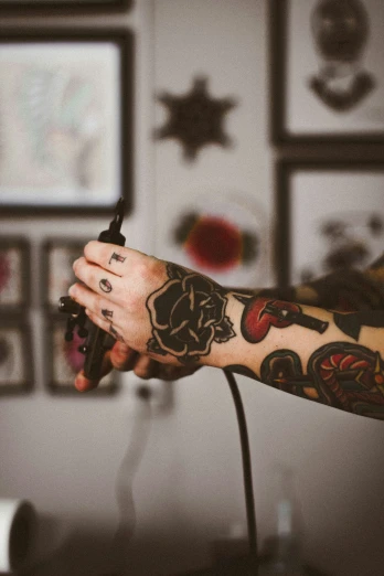tattooed arm with intricate red designs on the upper arm