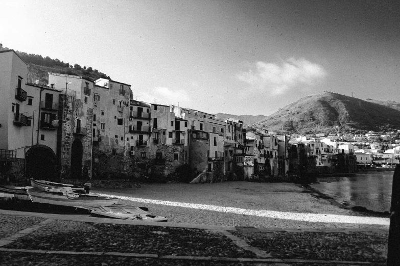 black and white po of several buildings by the water