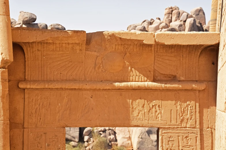 the face of a bird is shown in a doorway in an ancient rock - like structure