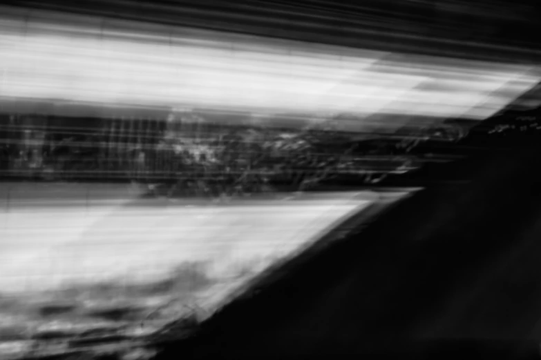 a black and white po of a train speeding by