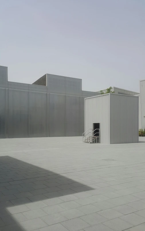 a grey building is seen on a clear day