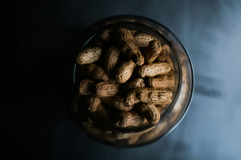 the peanut has been placed inside of the glass container