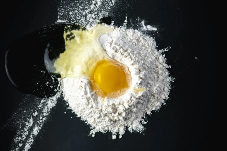 a pile of flour with eggs on top