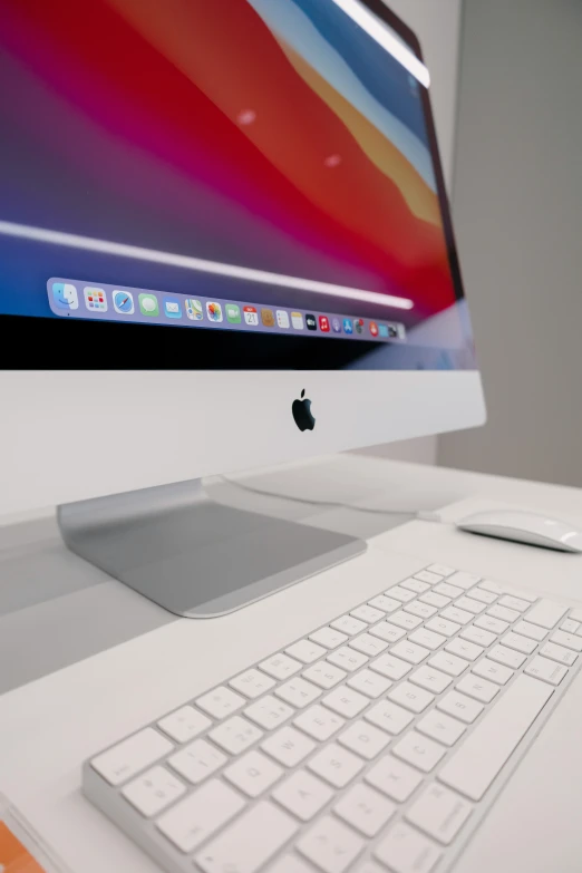 a close up of an apple computer with its keyboard and mouse