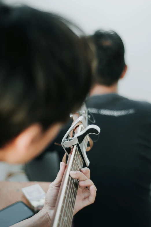 a woman is holding onto a guitar pick up item