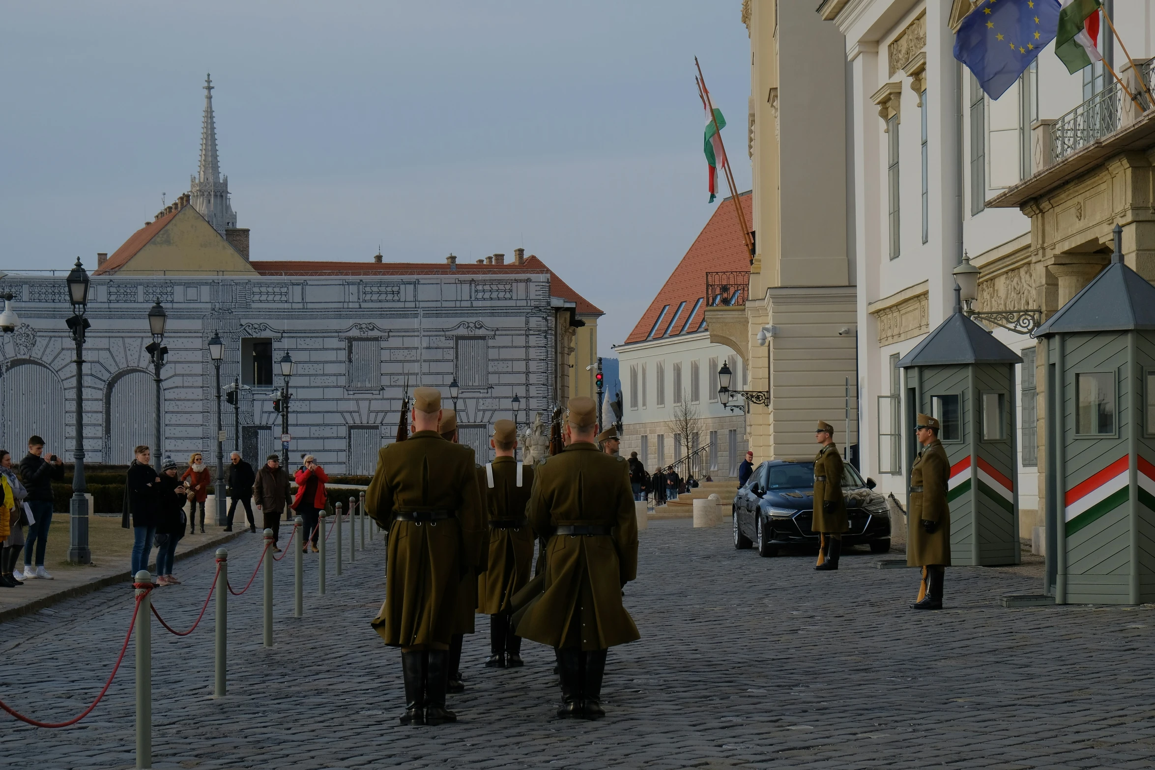 several men walking in a group in front of large buildings