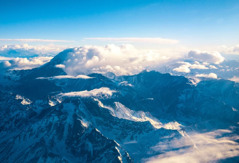 view of mountains from an airplane on cloudy day