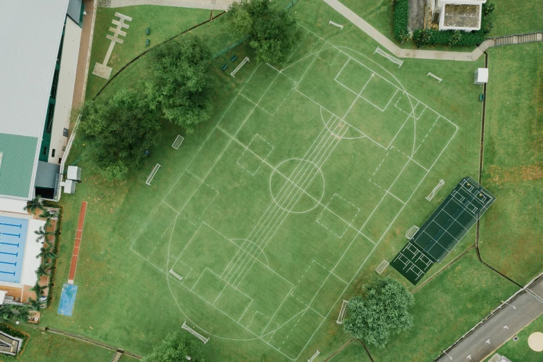 aerial view of a sports field with a parking lot