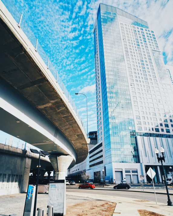 an elevated highway with a highway sign and a tall building