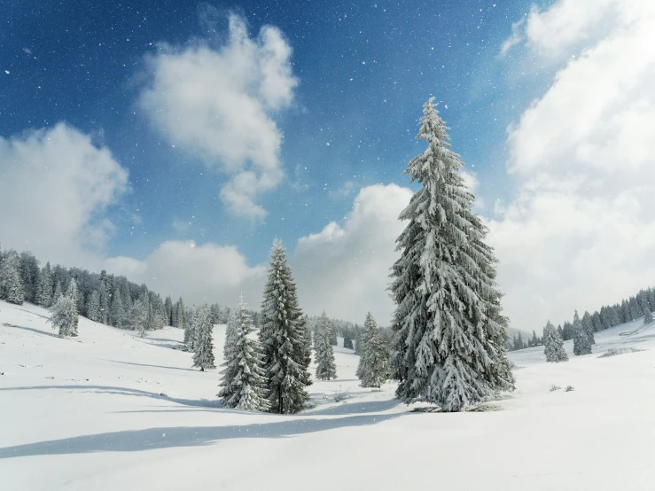 snow falling on a mountain in a partly cloudy sky