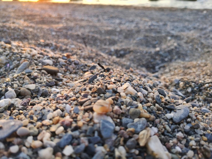 rocks, gravel, and water with a person taking picture