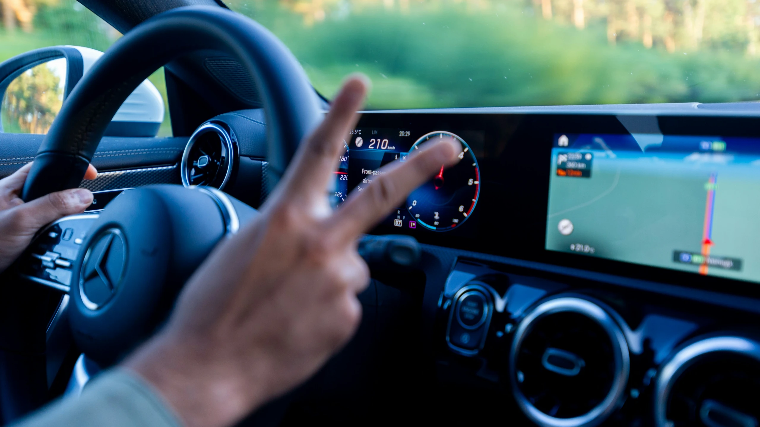 a person who is driving the car while listening to music