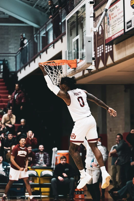 a basketball player is doing a dunk at the game