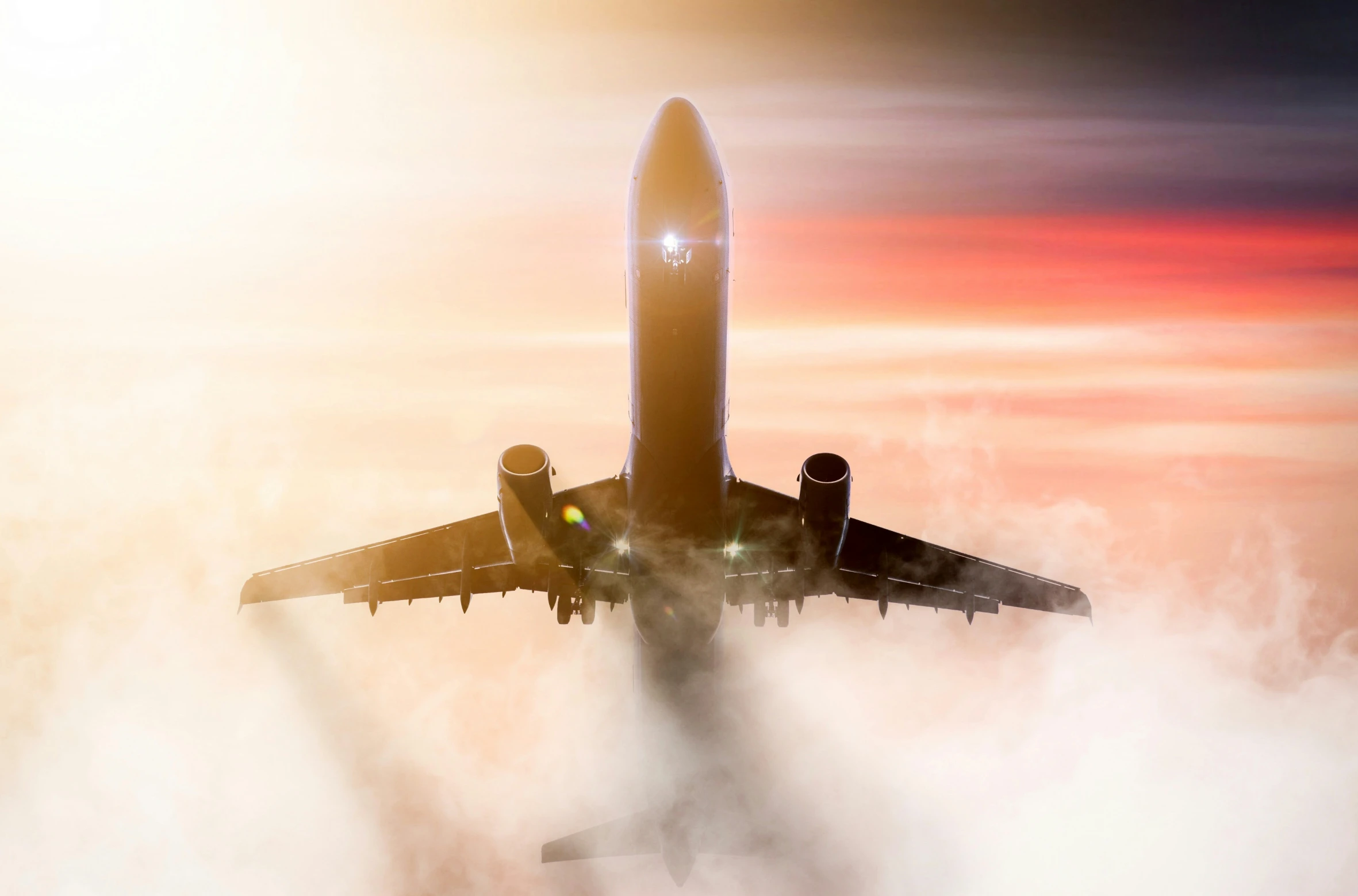 an airplane flying above the clouds on a sunny day