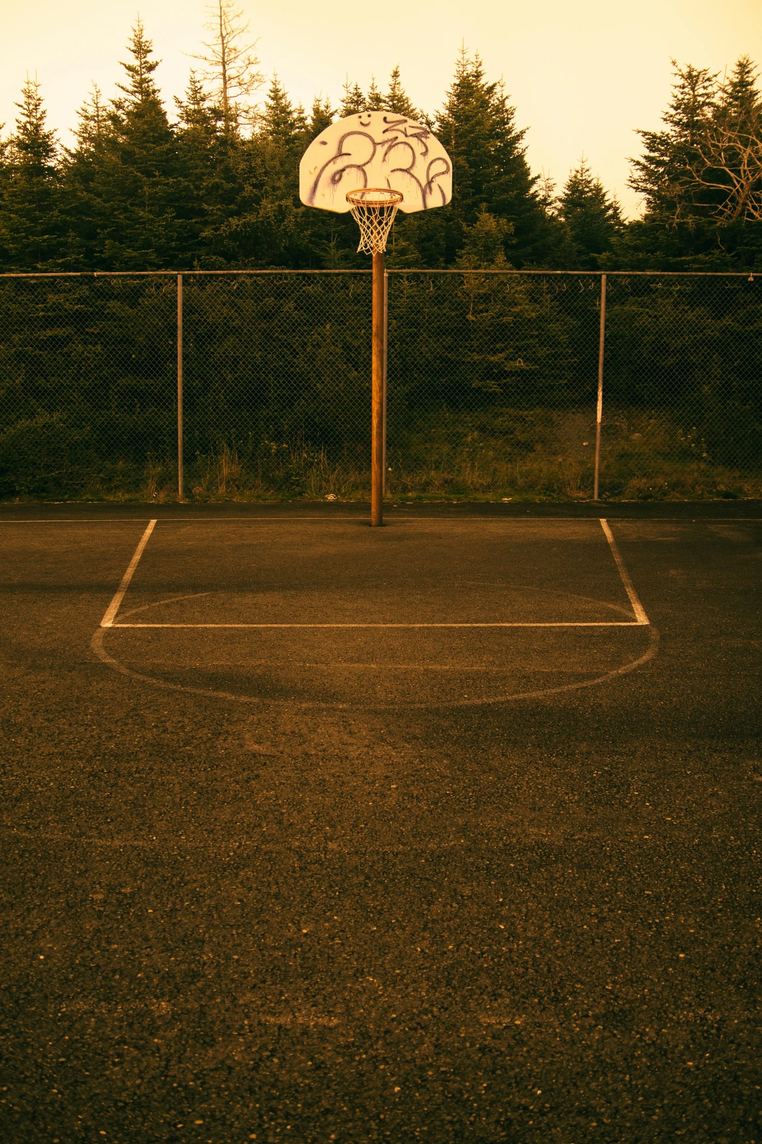 a basketball court is shown behind a chain link fence