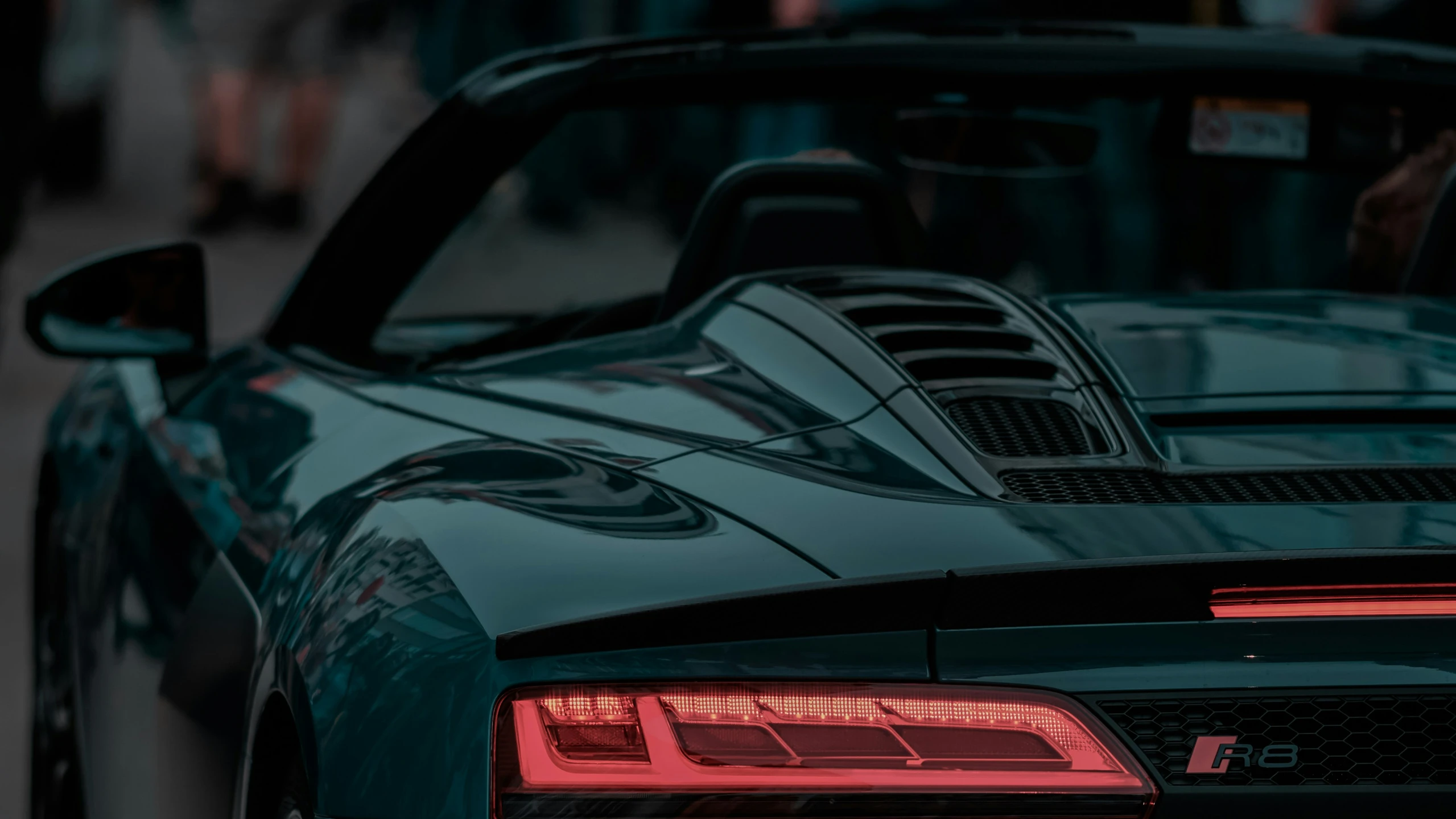 the hood of a sports car is visible in this image