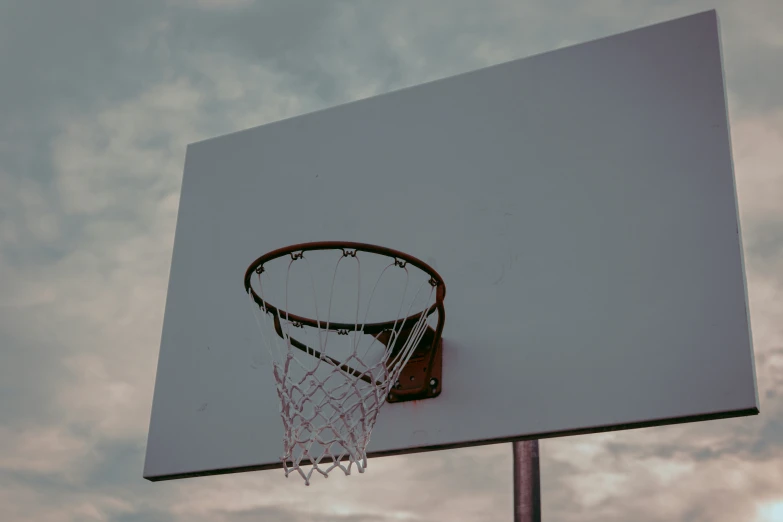 a basketball going through the hoop during an outdoor game