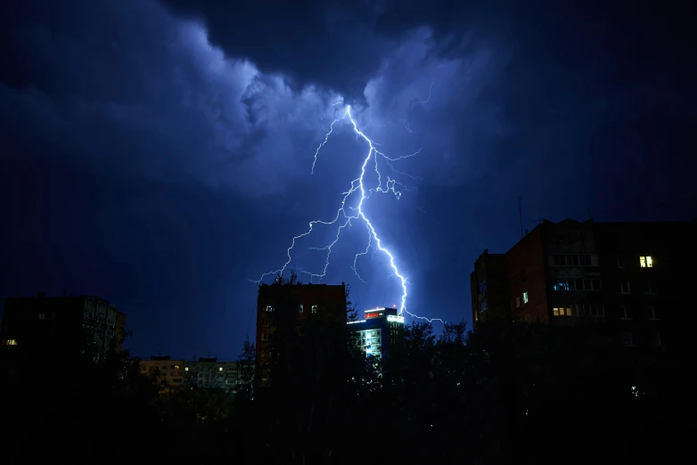 there is a lightning bolt hitting the sky over a city