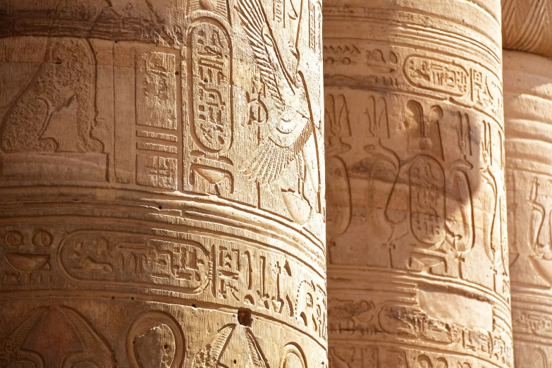 carved stone columns with decorative writing on them