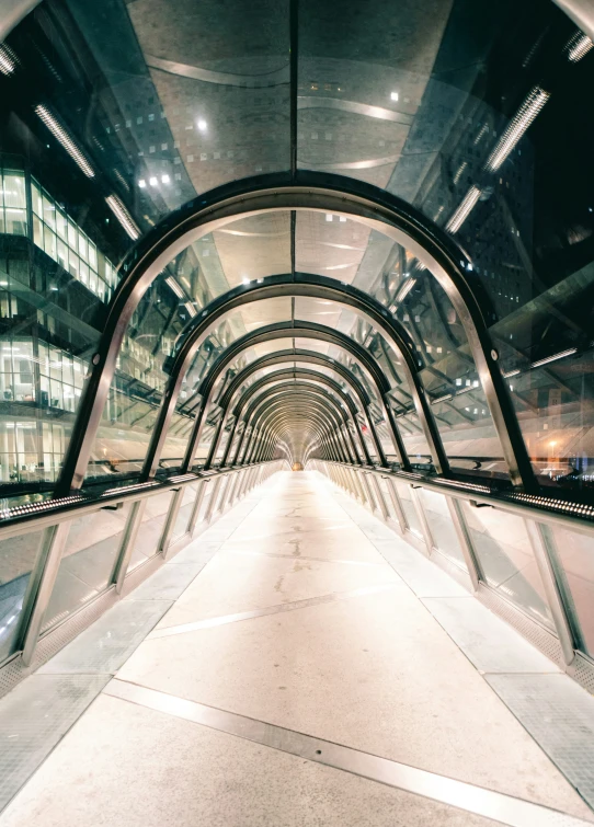 an escalator in the middle of a building at night