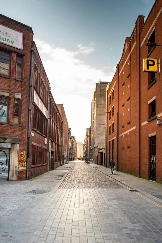 the street with two buildings is made of bricks