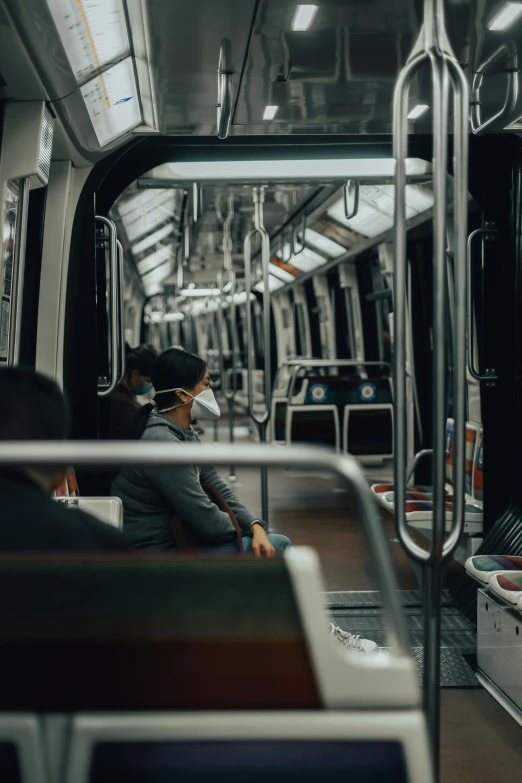 a lady sitting on a train with the seat down