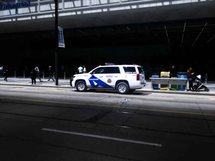 a vehicle sits parked along side a curb