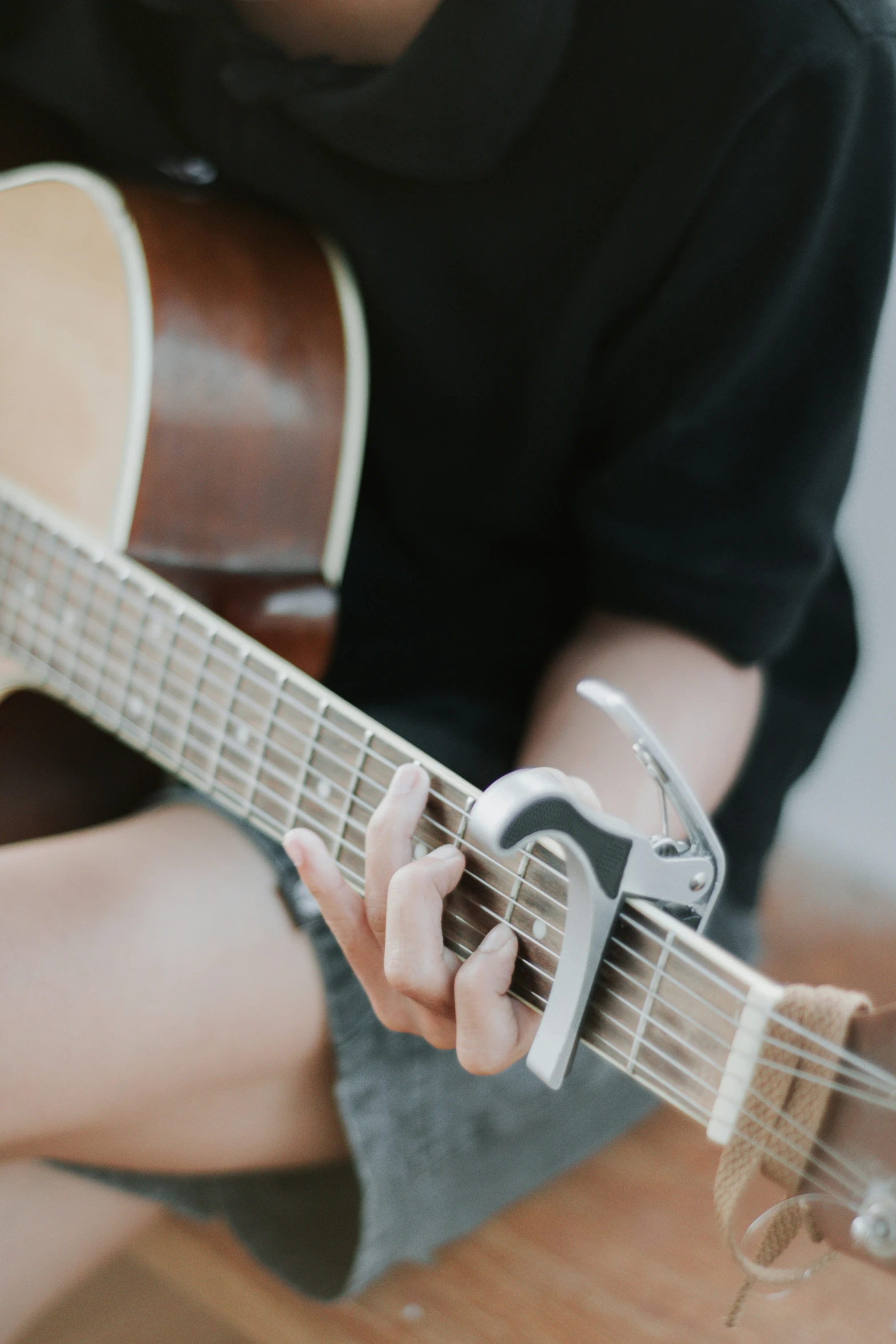 a person playing an acoustic guitar on the table