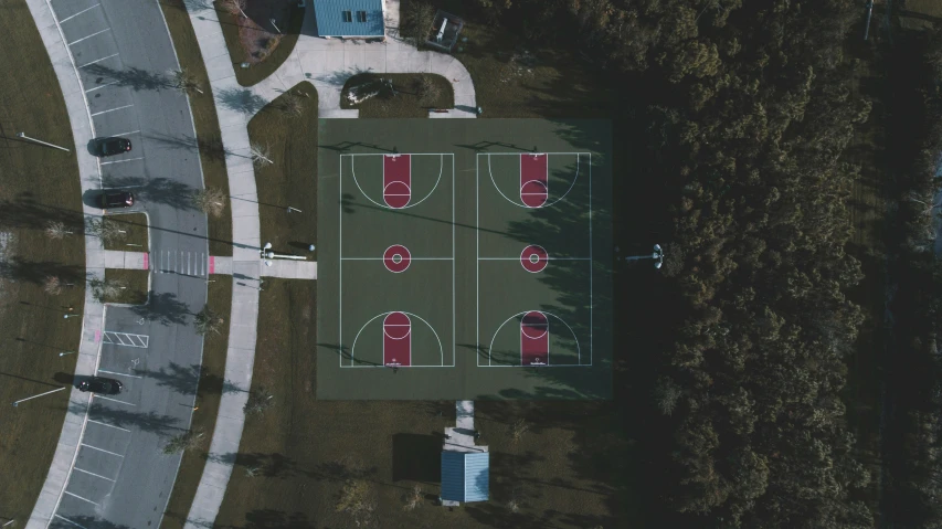 an aerial view of a field that is next to a building