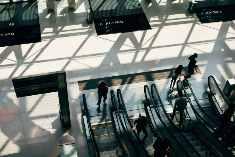 people riding up and down escalators in a station