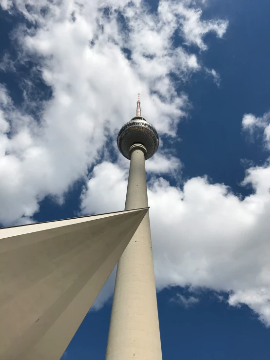 a very tall tower with some pretty clouds in the sky