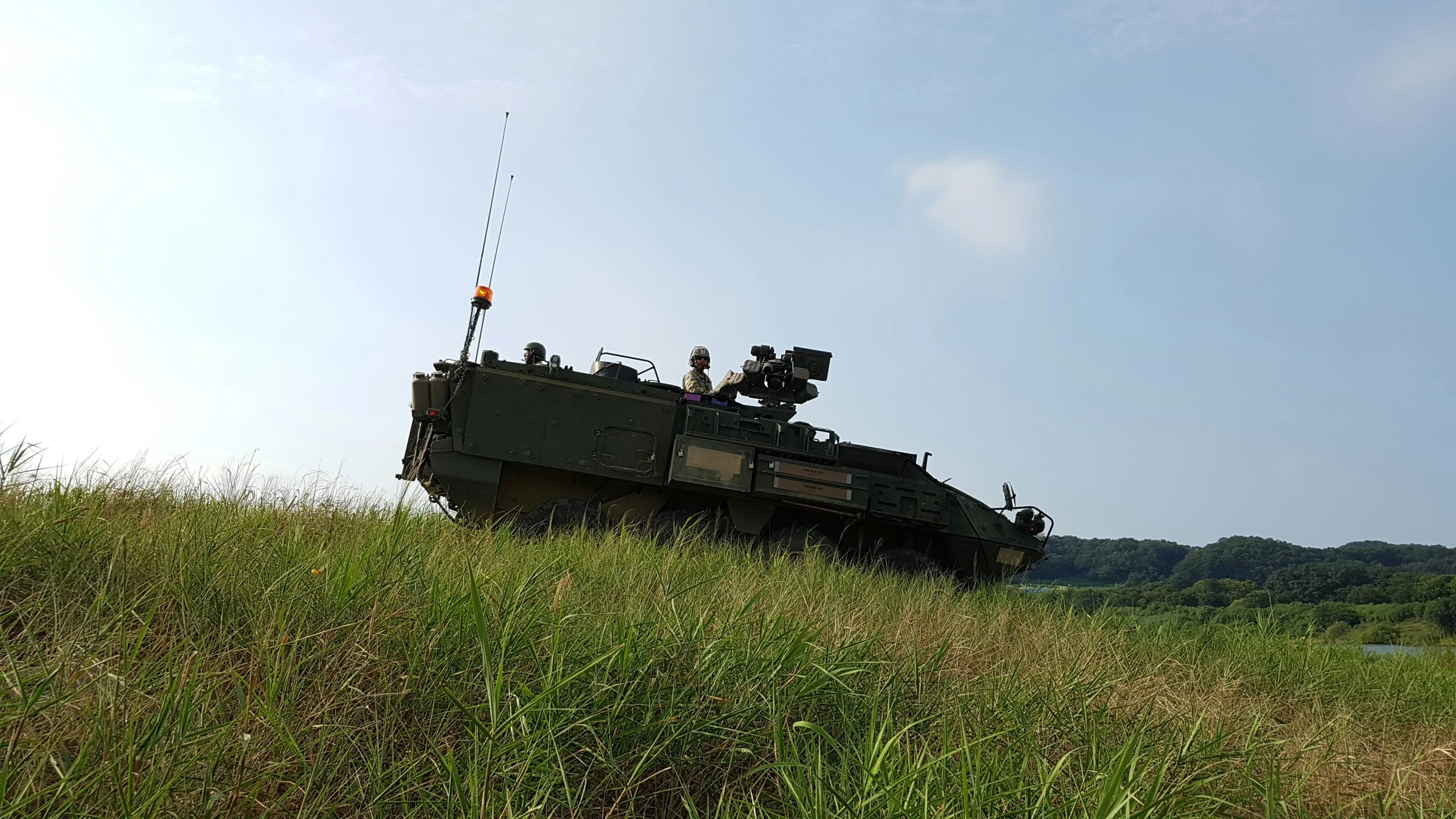 the army's tanks are in a field full of grass