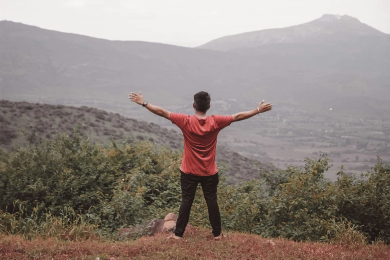 a person that is standing up with their arms out