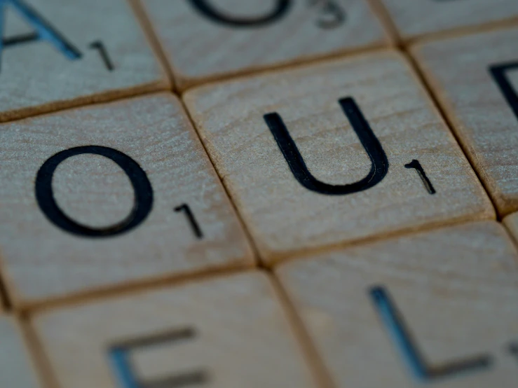 wooden crossword puzzle with word ouol written on it