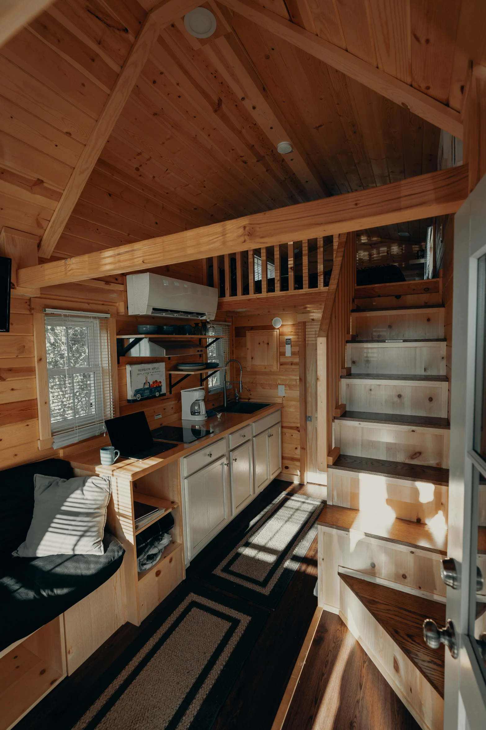 a kitchen that has stairs to go up in the building