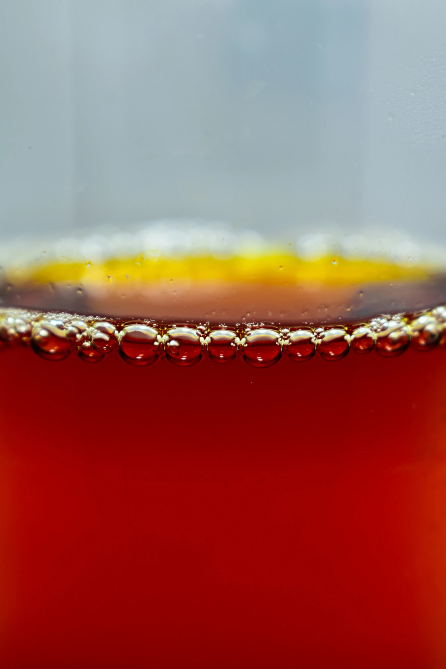 a close up of a red liquid with bubbles