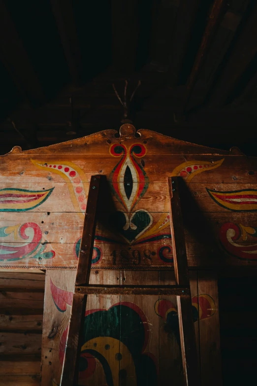 a wooden structure with some artwork painted on it