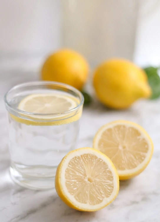 lemons on the counter with water and slices