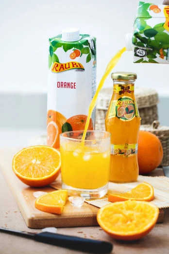 a wooden  board topped with oranges and juice