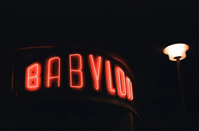 red sign that says barbllon in front of a street light